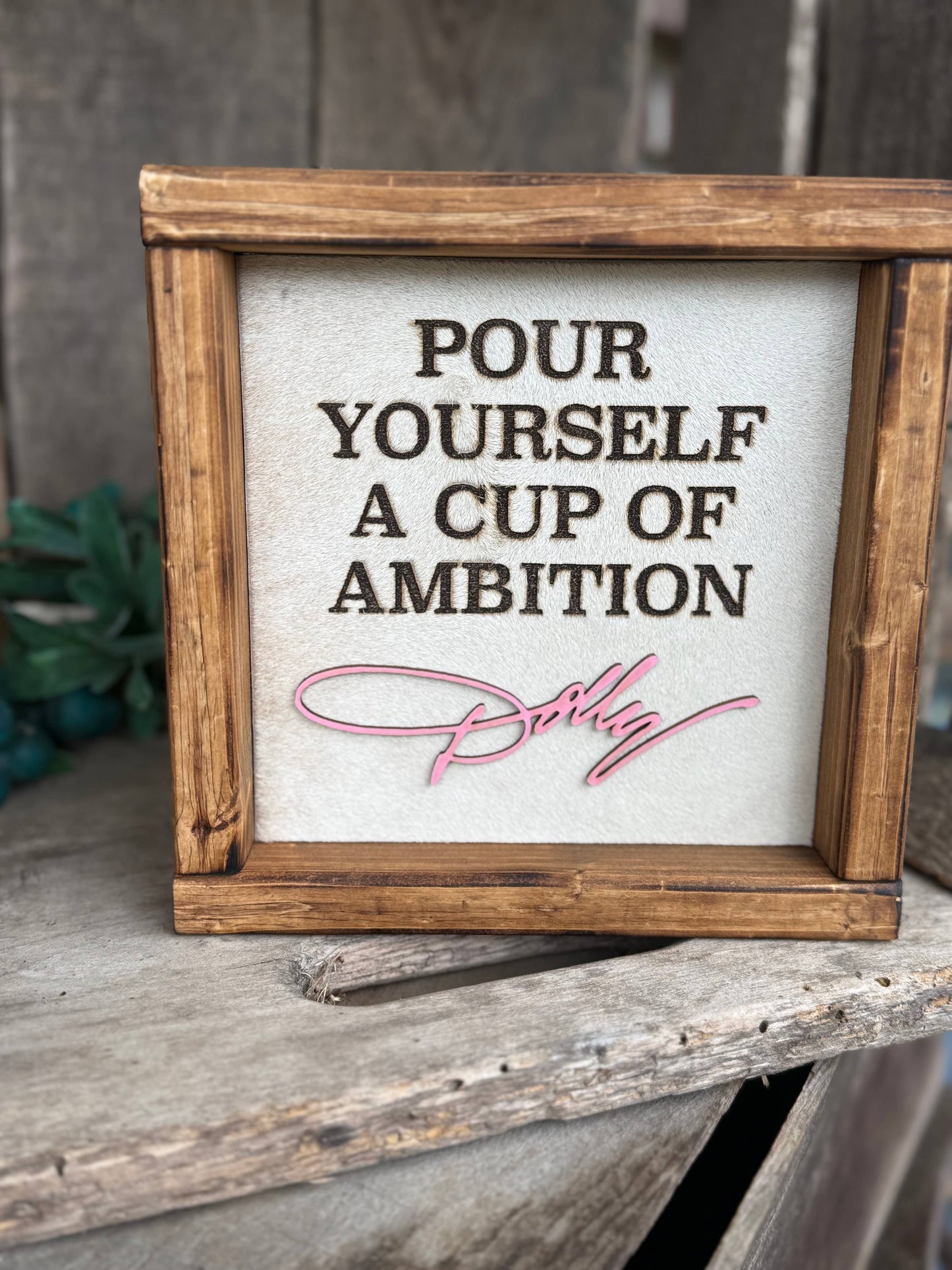 DOLLY PARTON FRAMED COWHIDE SIGN - POUR YOURSELF A CUP OF AMBITION!