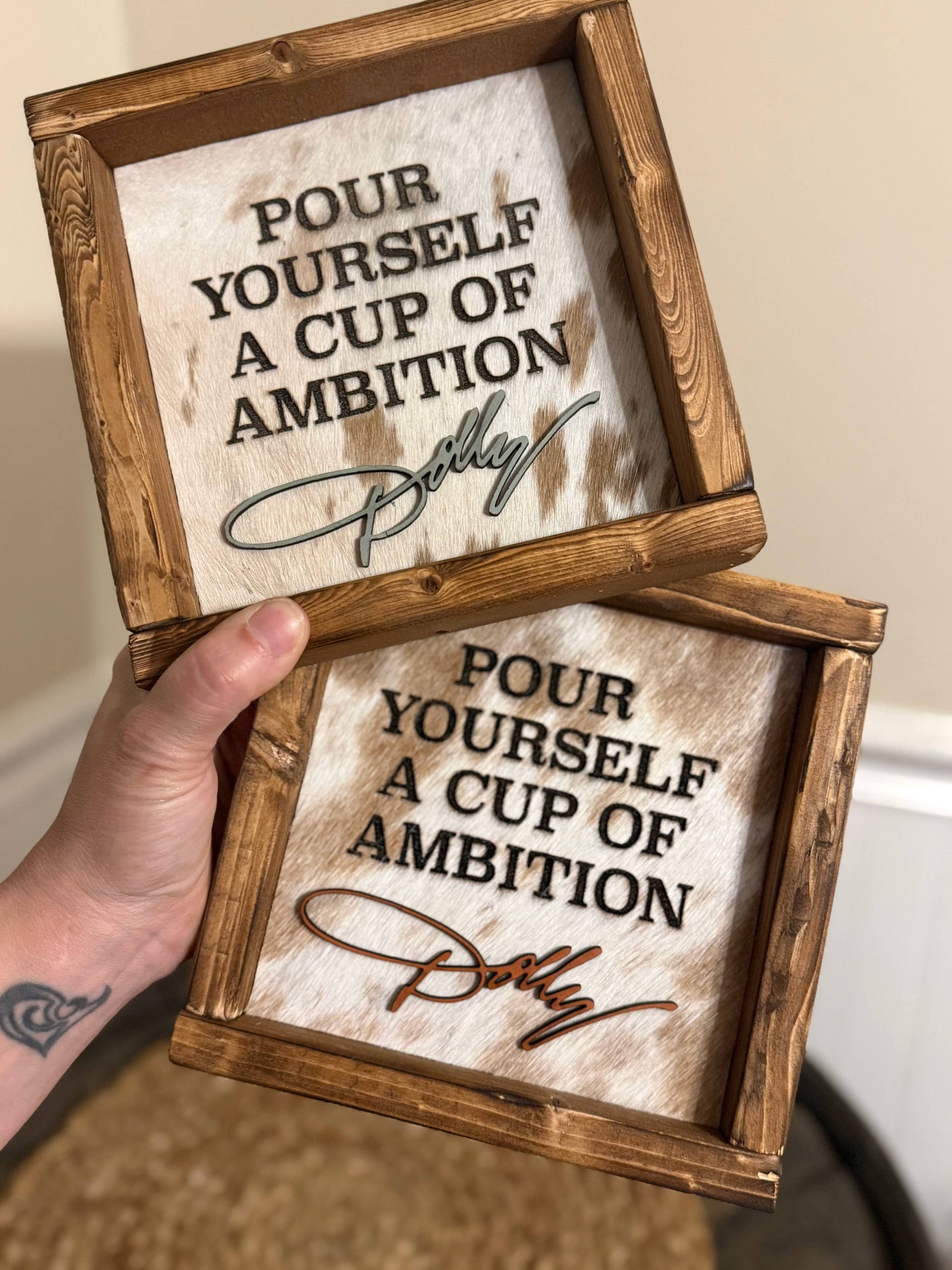 DOLLY PARTON FRAMED COWHIDE SIGN - POUR YOURSELF A CUP OF AMBITION!
